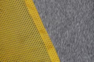 Top view of cloth textile surface. Close-up rumpled heater and knitted fabric texture with a thin striped pattern. Sport clothing fabric texture. Colored basketball shirt and heater hoodie photo