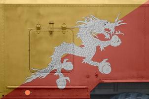 Bhutan flag depicted on side part of military armored truck closeup. Army forces conceptual background photo
