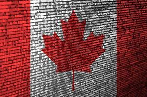 Canada flag  is depicted on the screen with the program code. The concept of modern technology and site development photo