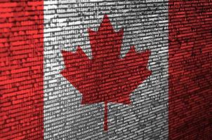 Canada flag  is depicted on the screen with the program code. The concept of modern technology and site development photo