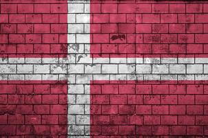 Denmark flag is painted onto an old brick wall photo