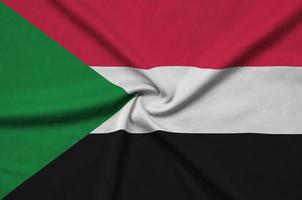 Sudan flag  is depicted on a sports cloth fabric with many folds. Sport team banner photo
