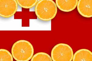 Tonga flag  in citrus fruit slices horizontal frame photo