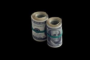 Bundle of US dollar bills isolated on black. Pack of american money with high resolution on perfect black background photo