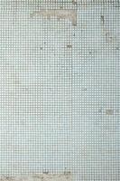 The texture of the old wall, decorated with a lot of square small tiles. Wall in the style of architecture of the Soviet Union photo
