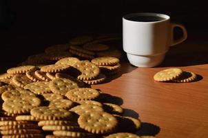 Small coffee cup and salted cracker photo