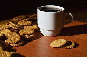 Small coffee cup and salted cracker photo