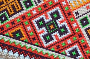 Traditional Ukrainian folk art knitted embroidery pattern on textile fabric photo