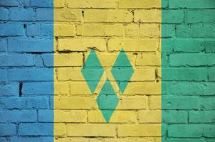 Saint Vincent and the Grenadines flag is painted onto an old bri photo