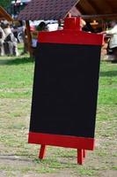 A large board as a menu for an open-air restaurant in a mountainous area. Free space for your text photo