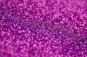 Pink decorative sequins. Background image with shiny bokeh lights from small elements photo