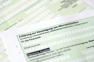 German statement on the assessment of retirement income close up. The concept of taxation and accountant paperwork Germany photo