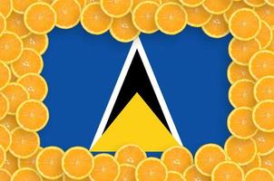 Saint Lucia flag  in fresh citrus fruit slices frame photo