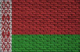 Belarus flag is painted onto an old brick wall photo