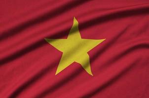 Vietnam flag  is depicted on a sports cloth fabric with many folds. Sport team banner photo