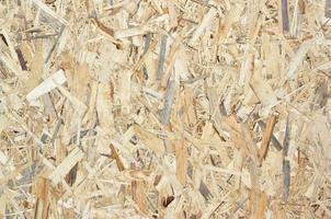 Texture of yellow wooden OSB plate close up photo