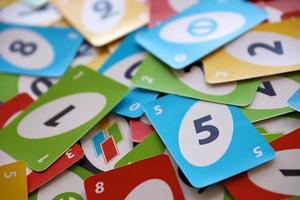 TERNOPIL, UKRAINE - MAY 15, 2022 Many colorful UNO game cards. UNO is an American shedding-type card game that is played with a specially printed deck photo
