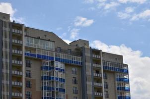 New or recently completed multi-storey residential building with windows and balconies. Russian type of house building photo