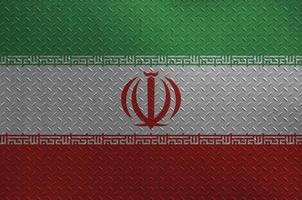 Iran flag depicted in paint colors on old brushed metal plate or wall closeup. Textured banner on rough background photo