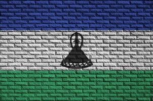 Lesotho flag is painted onto an old brick wall photo