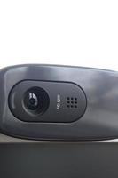 A modern web camera is installed on the body of a flat screen monitor. Device for video communication and recording of high quality video photo