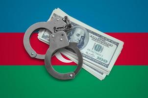 Azerbaijan flag  with handcuffs and a bundle of dollars. Currency corruption in the country. Financial crimes photo