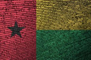 Guinea Bissau flag  is depicted on the screen with the program code. The concept of modern technology and site development photo