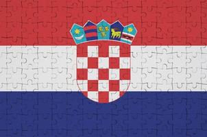 Croatia flag  is depicted on a folded puzzle photo
