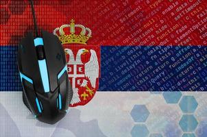 Serbia flag  and computer mouse. Digital threat, illegal actions on the Internet photo