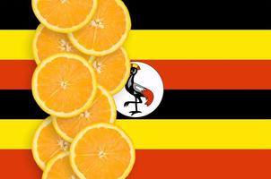 Uganda flag and citrus fruit slices vertical row photo