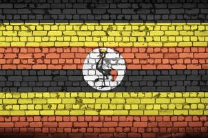 Uganda flag is painted onto an old brick wall photo