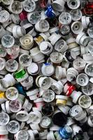 A pattern of many used and soiled nozzles from spray cans with aerosol paint. Background texture of the street art of drawing graffiti on the walls photo