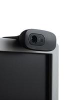 A modern web camera is installed on the body of a flat screen monitor. Device for video communication and recording of high quality video photo