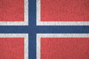 Norway flag depicted in bright paint colors on old relief plastering wall. Textured banner on rough background photo