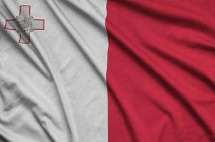 Malta flag  is depicted on a sports cloth fabric with many folds. Sport team banner photo