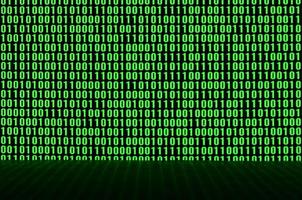 An image of a binary code made up of a set of green digits on a black background photo