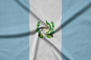 Guatemala flag  is depicted on a sports cloth fabric with many folds. Sport team banner photo