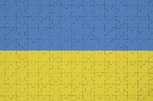 Ukraine flag  is depicted on a folded puzzle photo