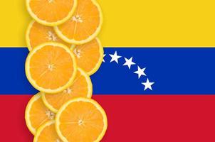 Venezuela flag and citrus fruit slices vertical row photo