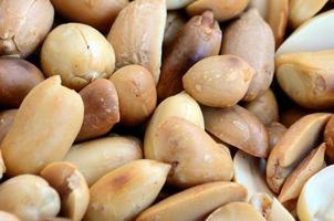Peanut. A lot of small yellow nuts without peel. Background texture photo