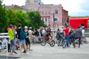 Defocused image of a lot of people with bmx bikes. Meeting of fans of extreme sports photo