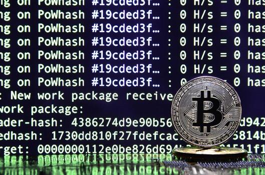 Two bitcoins lies on a videocard surface with background of screen display of cryptocurrency mining by using the GPUs photo