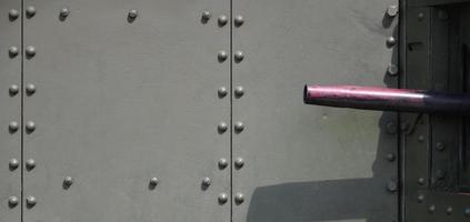 The texture of the wall of the tank, made of metal and reinforced with a multitude of bolts and rivets. Images of the covering of a combat vehicle from the Second World War with a guided machine gun photo