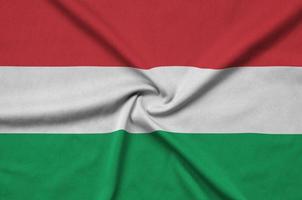 Hungary flag  is depicted on a sports cloth fabric with many folds. Sport team banner photo