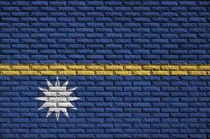 Nauru flag is painted onto an old brick wall photo