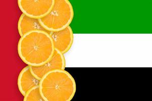 United Arab Emirates flag and citrus fruit slices vertical row photo