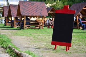 A large board as a menu for an open-air restaurant in a mountainous area. Free space for your text photo