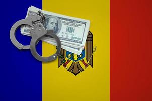 Moldova flag  with handcuffs and a bundle of dollars. The concept of breaking the law and thieves crimes photo