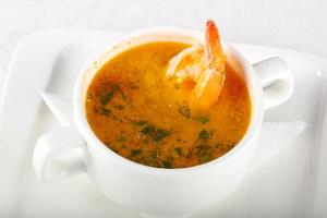 Prawn soup in a bowl on white background photo