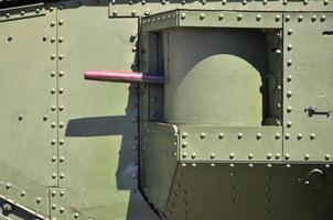 The texture of the wall of the tank, made of metal and reinforced with a multitude of bolts and rivets. Images of the covering of a combat vehicle from the Second World War with a guided machine gun photo